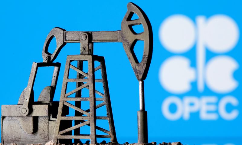 FILE PHOTO: A 3D printed oil pump jack is seen in front of displayed Opec logo in this