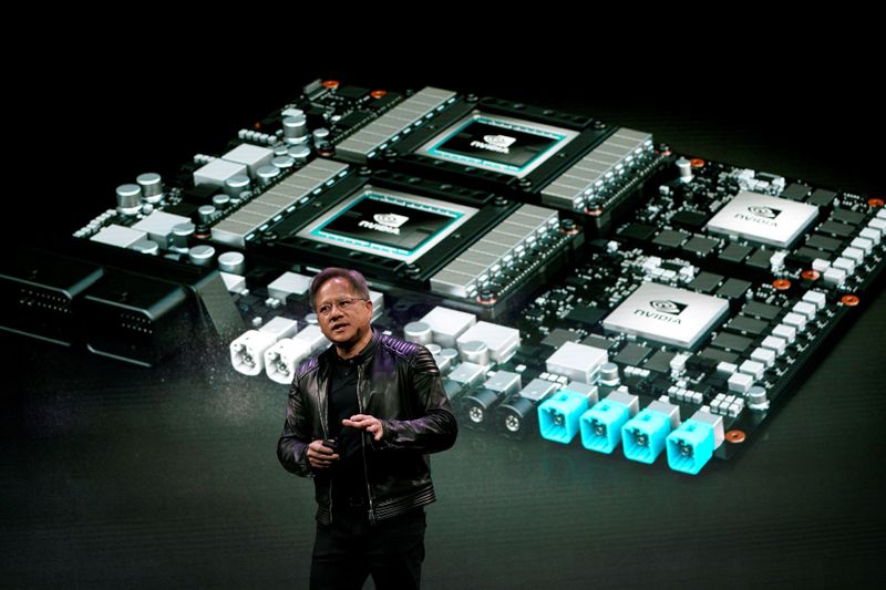 FILE PHOTO: Jensen Huang, CEO of Nvidia, shows the Drive Pegasus robotaxi AI computer at his