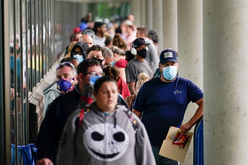 FILE PHOTO: Hundreds of people line up outside a Kentucky Career Center hoping to find