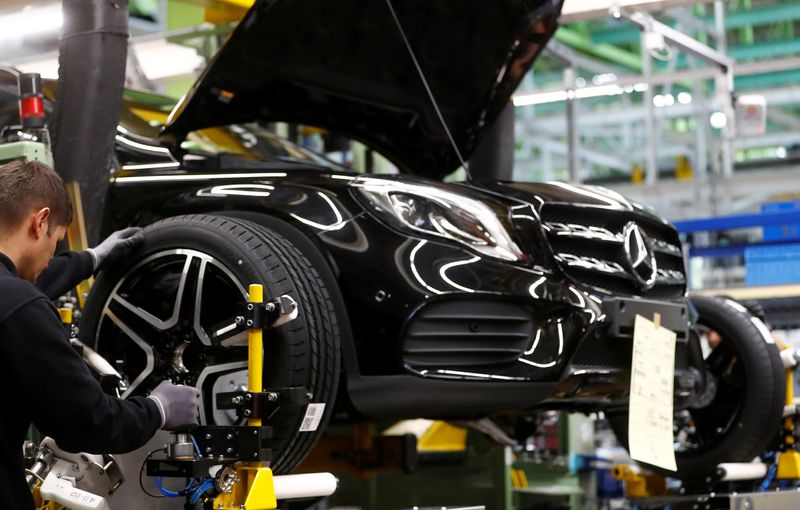 FILE PHOTO: An employee of German car manufacturer Mercedes Benz installs wheel at a A-class